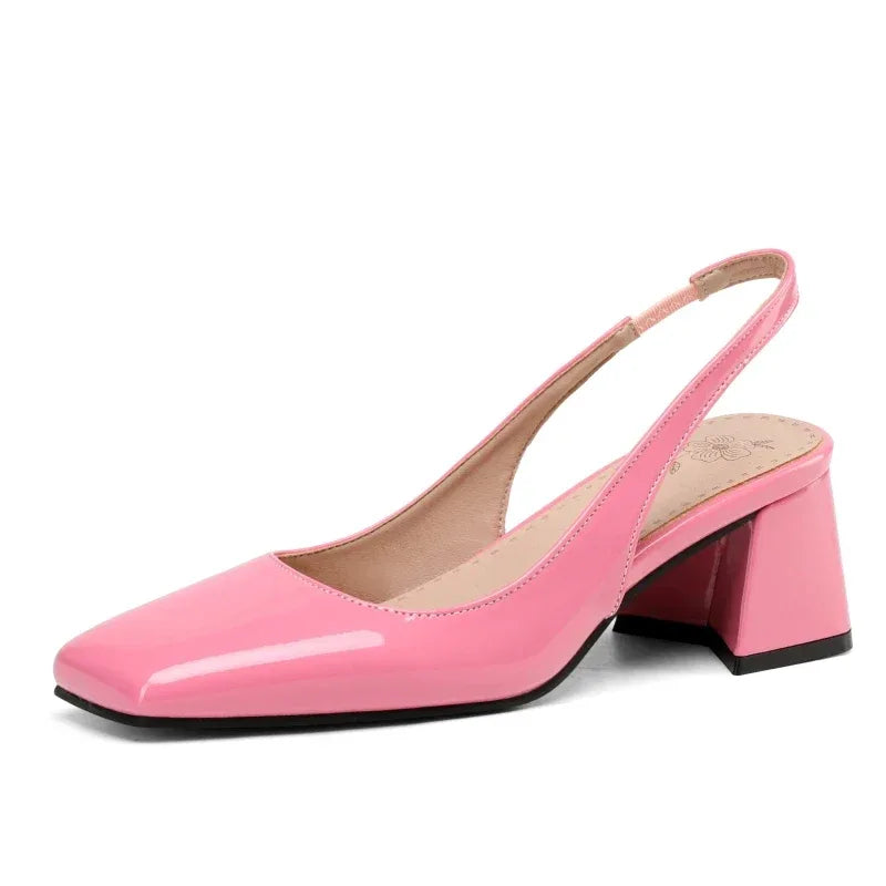 Pink patent leather slingback pumps, front-angled studio display