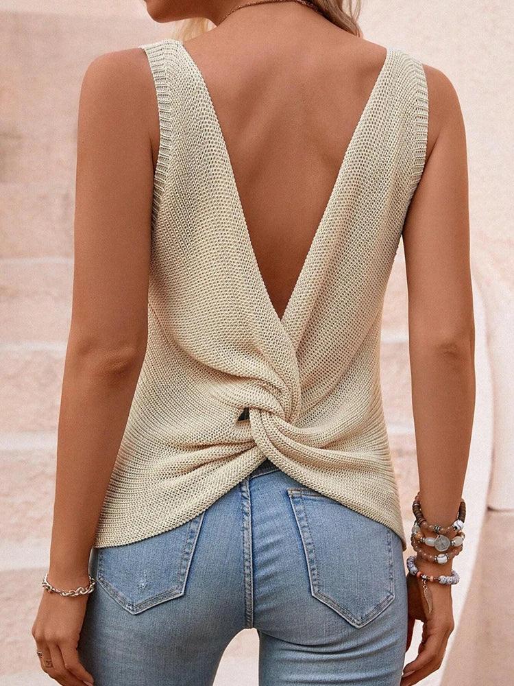 Back angled view of ivory twist-back sleeveless knit top highlighting twisted drape