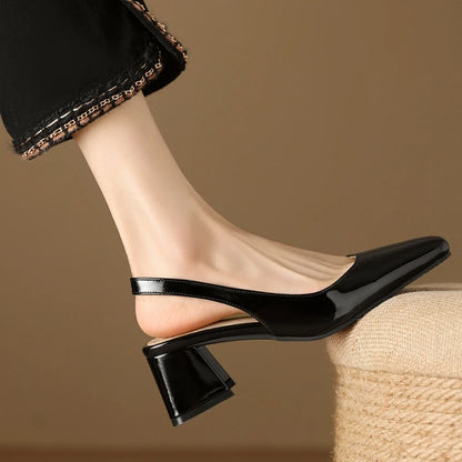 Black patent leather slingback pumps, side view
