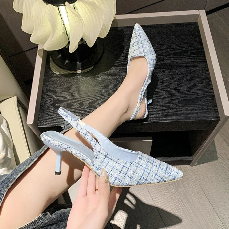 Blue tweed slingback heels with pointed toe and low kitten heel on wooden table