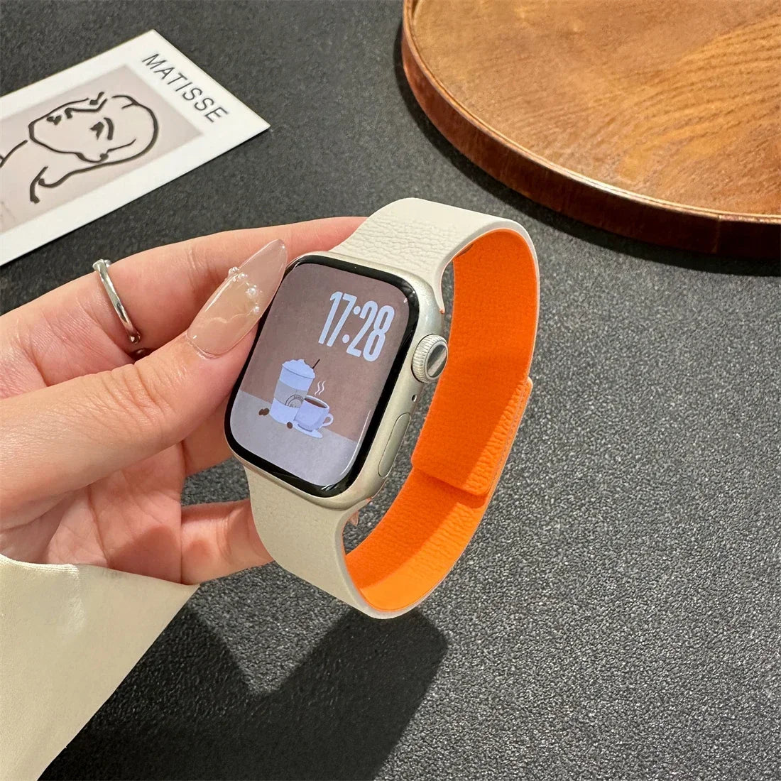 Pink magnetic leather loop Apple Watch band on wrist close-up