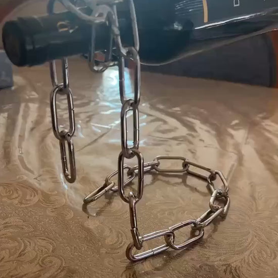 Bronze chain holder standing upright without a bottle, casting shadow