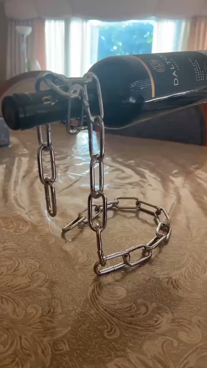 Bronze chain holder standing upright without a bottle, casting shadow