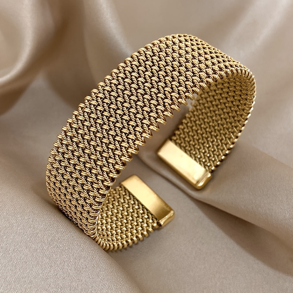 Front-facing view of gold woven bracelet with open ends