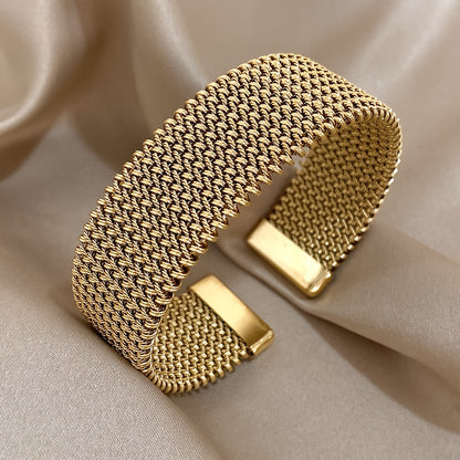 Front-facing view of gold woven bracelet with open ends
